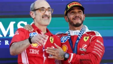Lewis Hamilton celebrates on the podium with his trophy after winning the Barcelona Grand Prix, standing alongside his Ferrari race engineer Carlos Santi. © Ferrari Media Centre