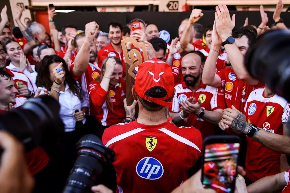Lewis Hamilton is congratulated by an enthusiastic Ferrari team after his victory. © Ferrari Media Centre