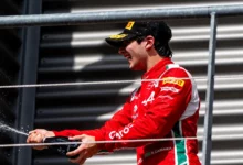 Rafael Câmara spraying champagne on the podium in Ferrari Driver Academy colours