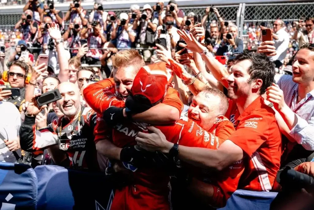 Lewis Hamilton celebrates his maiden win in red with his Ferrari crew © Ferrari Media Centre