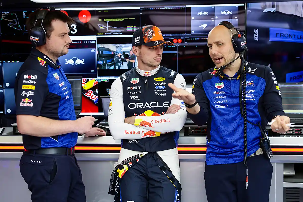 Max Verstappen talking with Gianpiero Lambiase during a debrief, connected to the focus keyphrase: Verstappen torpedo Red Bull departures exposed.