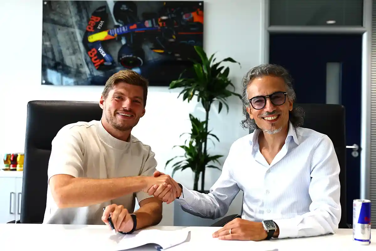 Max Verstappen and Laurent Mekies photographed in Milton Keynes during the contract re‑signing that extends Verstappen’s Red Bull deal until 2030, captured by Mark Thompson/Getty Images.