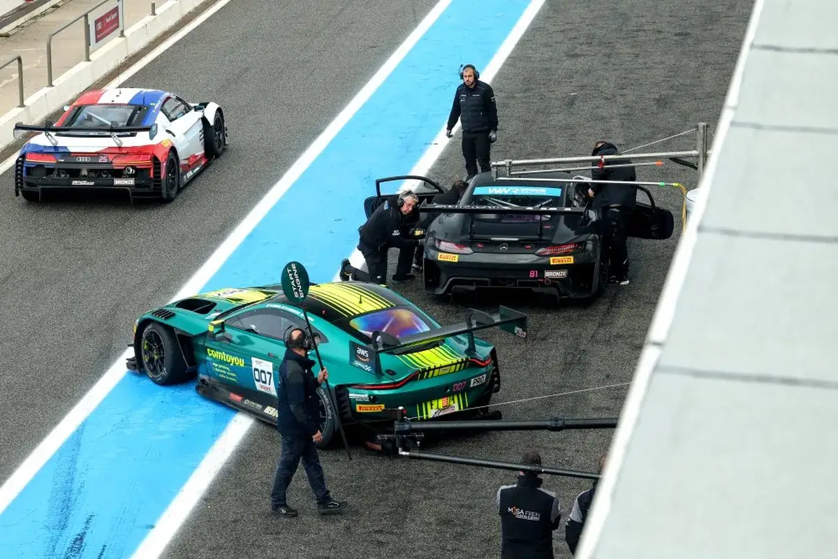GT World Challenge cars in the pit lane with PRO and BRONZE class labels visible on the doors