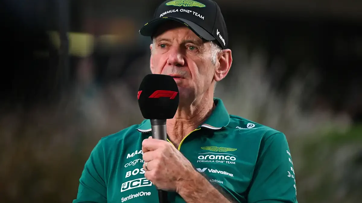 Adrian Newey speaks to the media in Aston Martin team kit