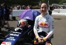 Alisha Palmowski beside her F1 Academy car at the Goodwood Festival of Speed.