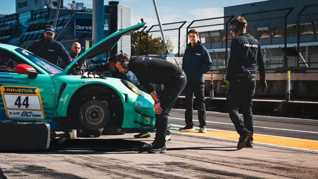 Falken Motorsports mechanics working on their Porsche in the Nürburgring pit lane