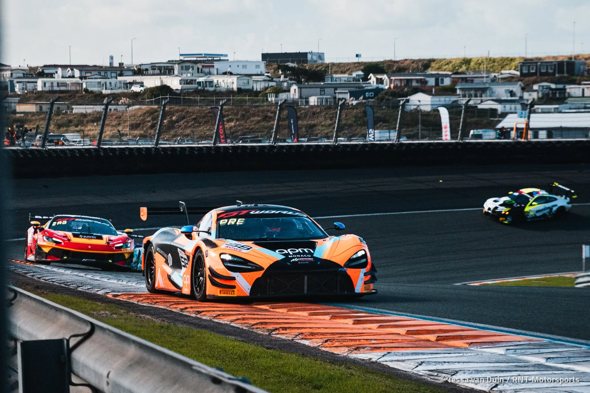 The number 58 Garage 59 McLaren 720S GT3 Evo over the kerbs at Zandvoort