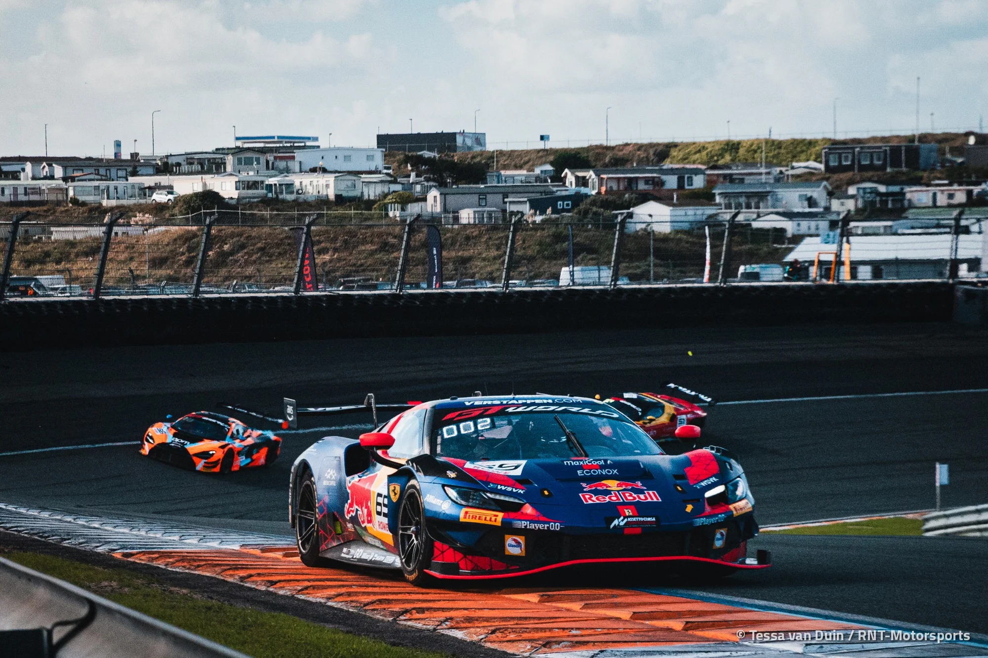 The number 69 Emil Frey Racing Ferrari riding the kerbs at Zandvoort
