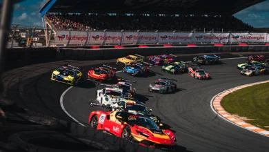 The GT World Challenge field three wide through the banked Hugenholtzbocht on the first lap of Race 2 at Zandvoort