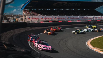 Both Emil Frey Racing Ferraris at the front of the field at the Hugenholtzbocht on the opening lap of Race 2 at Zandvoort