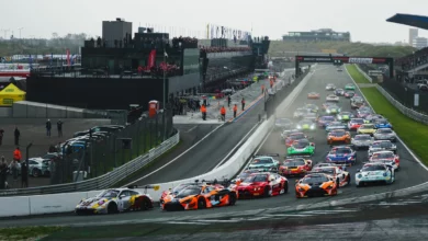 The number 2 Boutsen VDS Porsche and the number 58 Garage 59 McLaren side by side leading the field at the start of Race 1 at Zandvoort