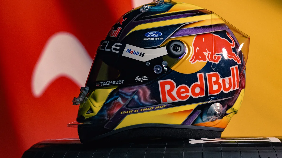 Isack Hadjar's 2026 Red Bull helmet resting on a Pirelli tyre