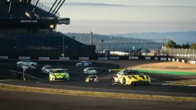 A group of GT3 cars including the Manthey Porsche 911 GT3 R running through the Grand Prix circuit at the Nurburgring during the NLS8 weekend