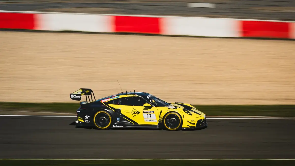A yellow Porsche 911 GT3 at speed during Friday practice at the Nurburgring