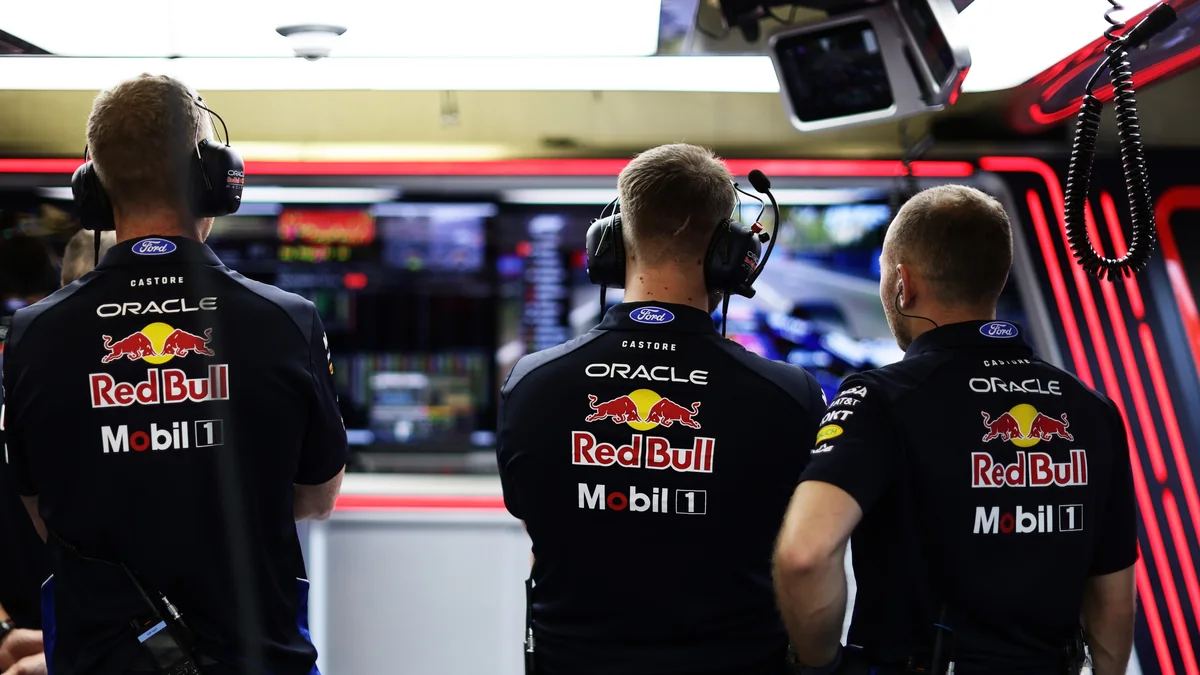 Red Bull Racing team members with headsets watching the timing screens in the garage in Baku
