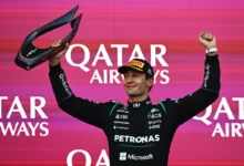 George Russell lifts the winner's trophy on the podium of the 2026 Azerbaijan Grand Prix in Baku