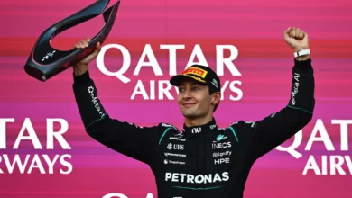 George Russell lifts the winner's trophy on the podium of the 2026 Azerbaijan Grand Prix in Baku