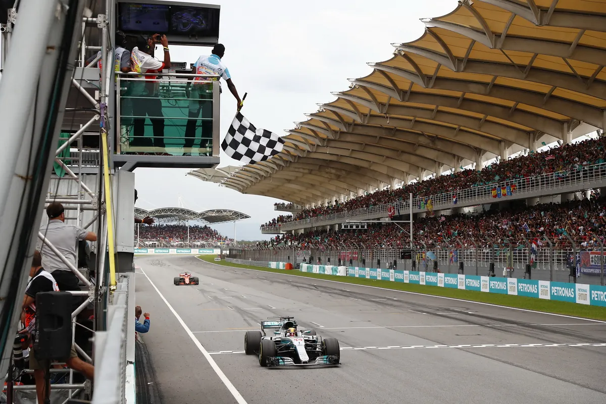 Lewis Hamilton's Mercedes takes the chequered flag on the Sepang main straight at the 2017 Malaysian Grand Prix