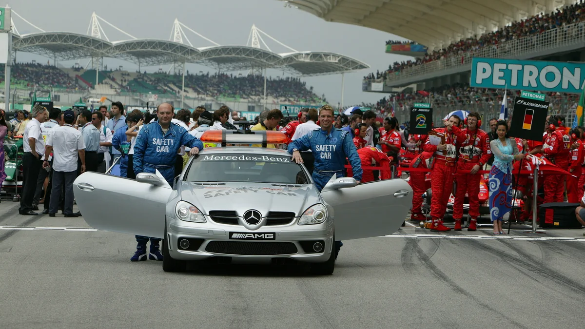The Mercedes-AMG safety car and its crew on the Sepang grid in the mid-2000s