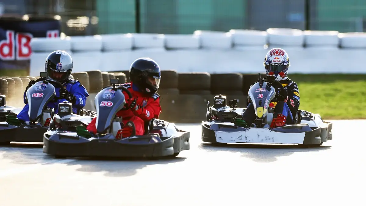 Max Verstappen overtakes two rival karts at Silverstone.