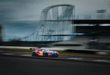 The number 3 Verstappen Racing Mercedes-AMG GT3 Evo panning past the roller coaster during the Nürburgring 24 Hours