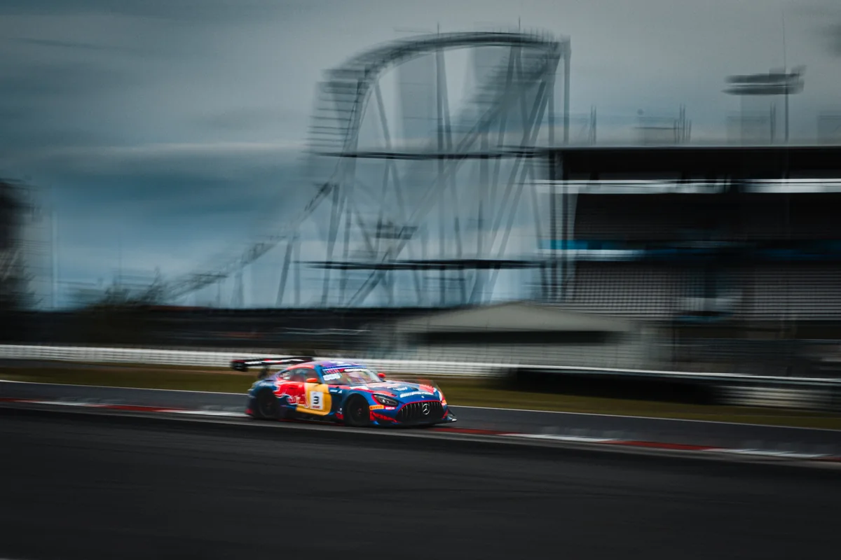 The number 3 Verstappen Racing Mercedes-AMG GT3 Evo panning past the roller coaster during the Nürburgring 24 Hours