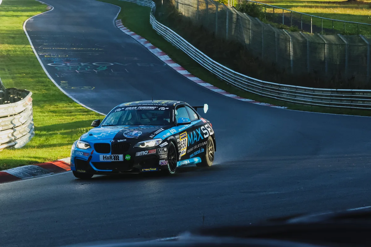 The number 650 Adrenalin Motorsport BMW M240i Racing Cup in black and blue on the Nordschleife during NLS10