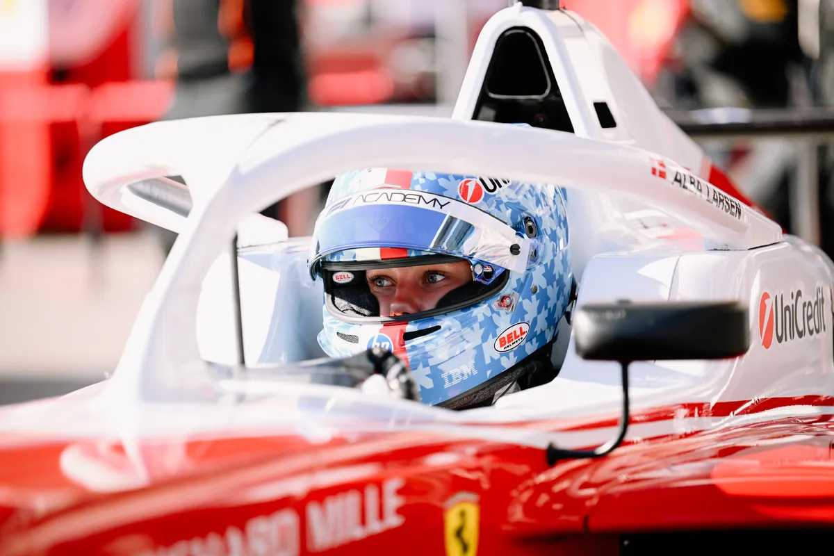 Alba Larsen in a Ferrari-liveried F1 Academy car with a blue helmet