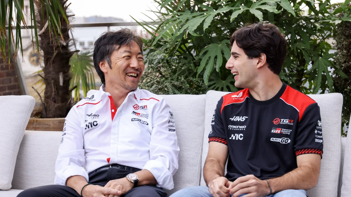 Haas team principal Ayao Komatsu and Rafael Câmara laughing on a sofa during the 2027 announcement