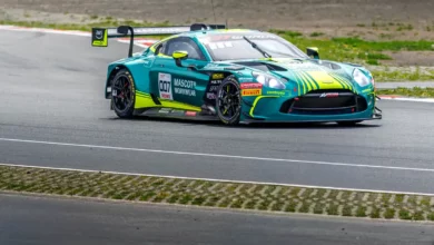 The green and yellow #7 Comtoyou Racing Aston Martin Vantage GT3 on track at the Nürburgring