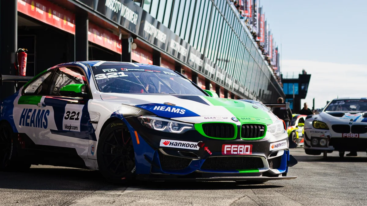 Blue, white and green BMW M4 number 321 in the pit lane at Circuit Zandvoort