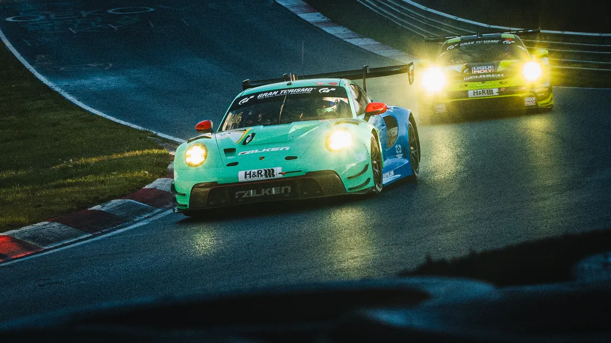 The number 44 Falken Motorsports Porsche 911 GT3 R with its headlights on during NLS10 qualifying at the Nurburgring