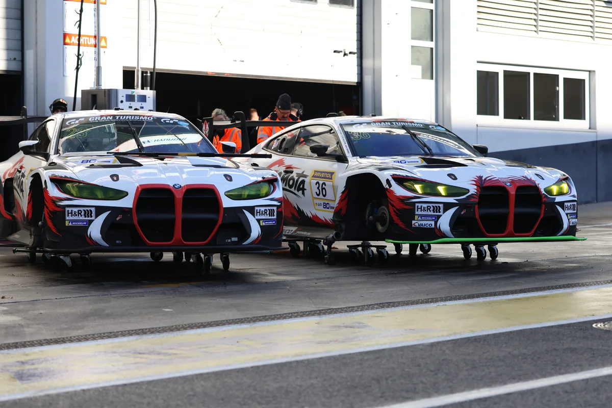 The two Gamota Racing BMW M4 GT3 EVOs, numbers 23 and 36, side by side in the pit lane at the Nurburgring