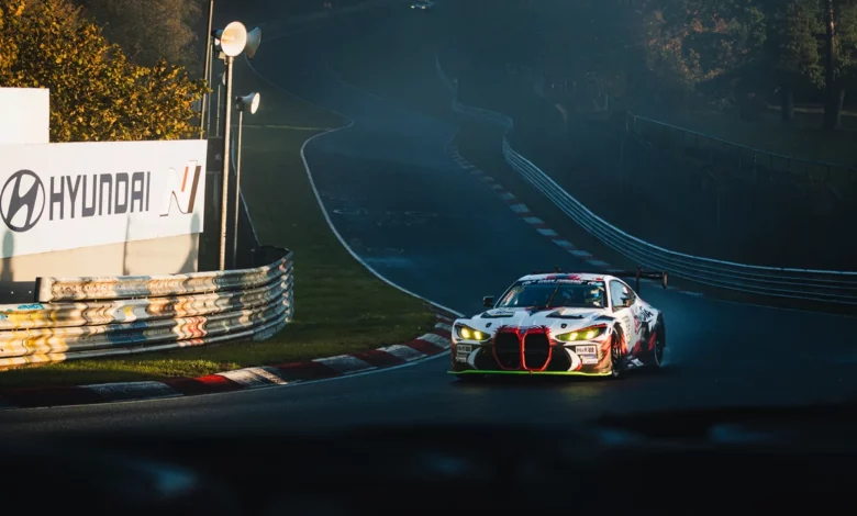 The number 36 Gamota Racing BMW M4 GT3 EVO in low morning sun with mist behind it during NLS10 qualifying at the Nurburgring