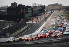 The #2 Boutsen VDS Porsche 911 GT3 R ahead of a McLaren and a BMW into turn 1 at the start of a GT World Challenge race at Zandvoort in September 2026