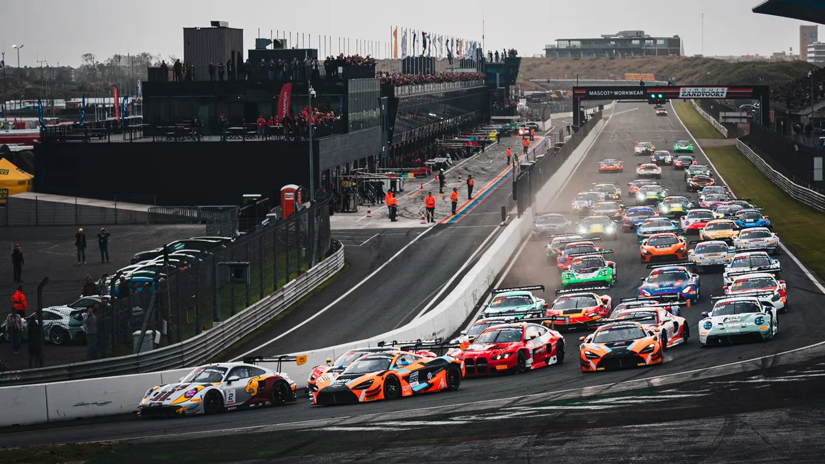 The #2 Boutsen VDS Porsche 911 GT3 R ahead of a McLaren and a BMW into turn 1 at the start of a GT World Challenge race at Zandvoort in September 2026
