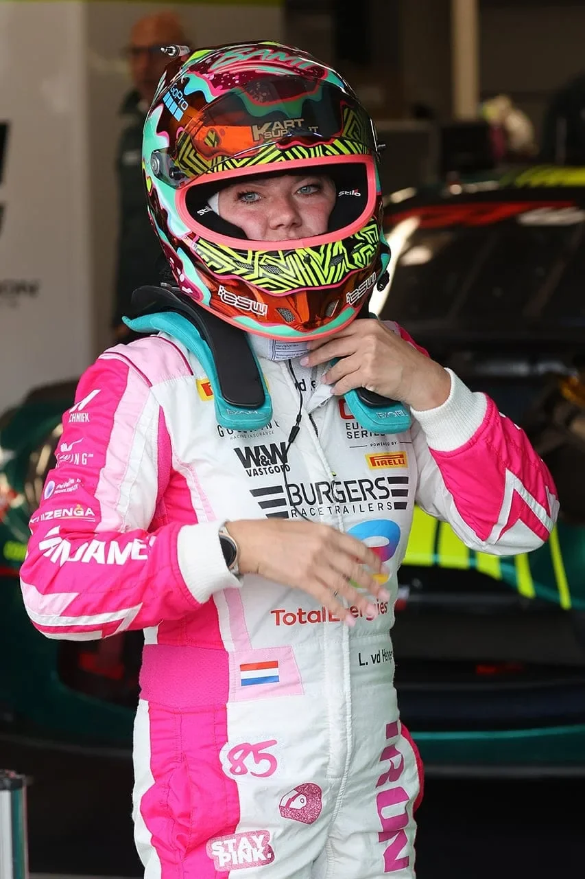 Laura van den Hengel in her pink Iron Dames race suit and helmet in the pit box