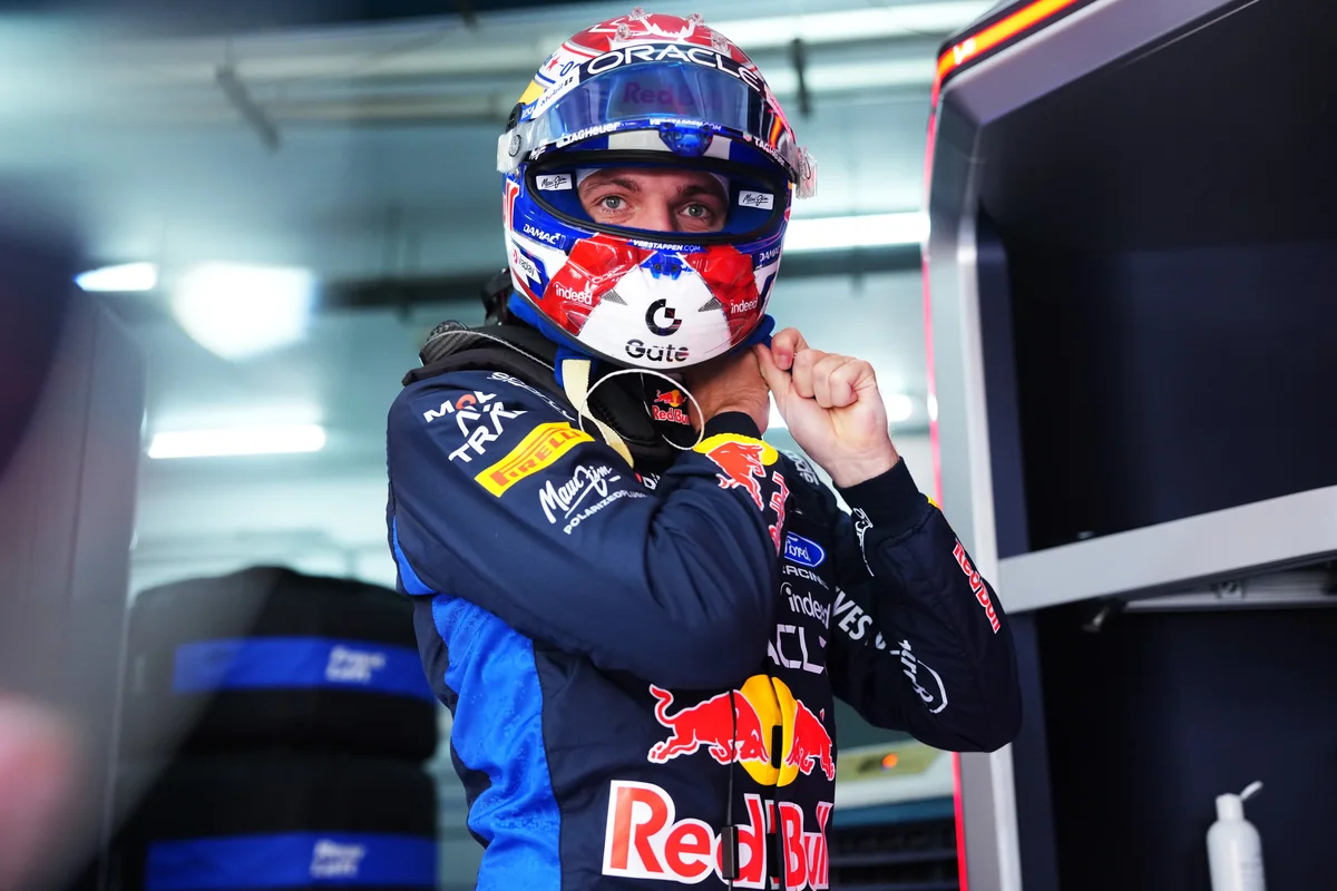 Max Verstappen putting on his helmet in the Red Bull garage before practice at Sepang
