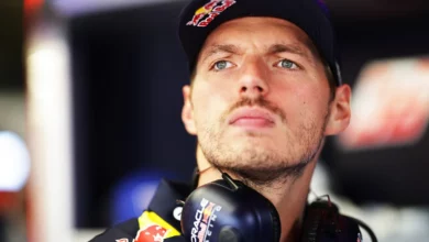 Max Verstappen in the Red Bull Racing garage, wearing headphones around his neck