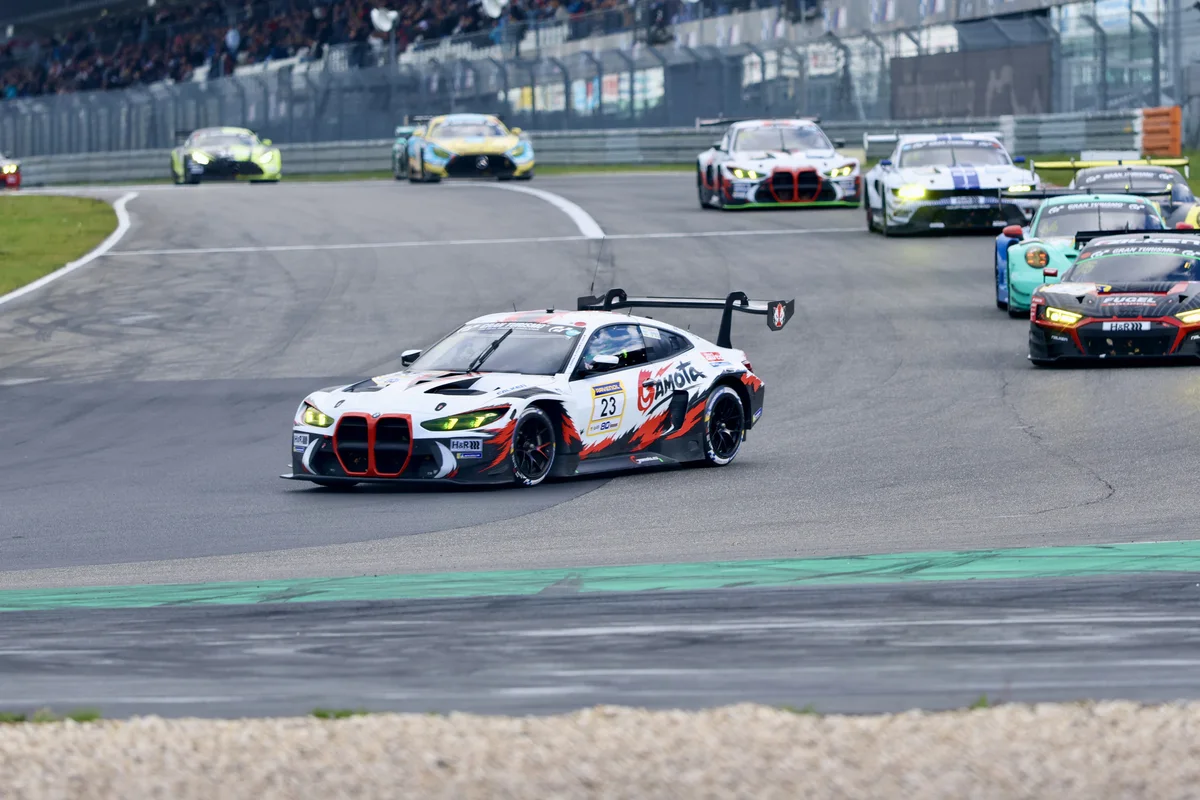 The number 23 Gamota Racing BMW leads the number 75 Audi and the number 44 Falken Porsche on the Nurburgring Grand Prix circuit during NLS10