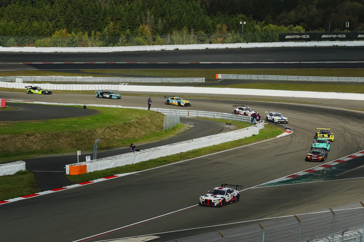 The number 23 Gamota Racing BMW leads a train of GT3 cars through a corner of the Nurburgring GP circuit early in the NLS10 race