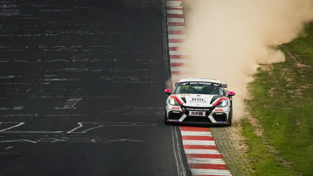 A Porsche 718 Cayman GT4 in the CUP3 class kicks up dust on the Nordschleife during the NLS double header in September 2026