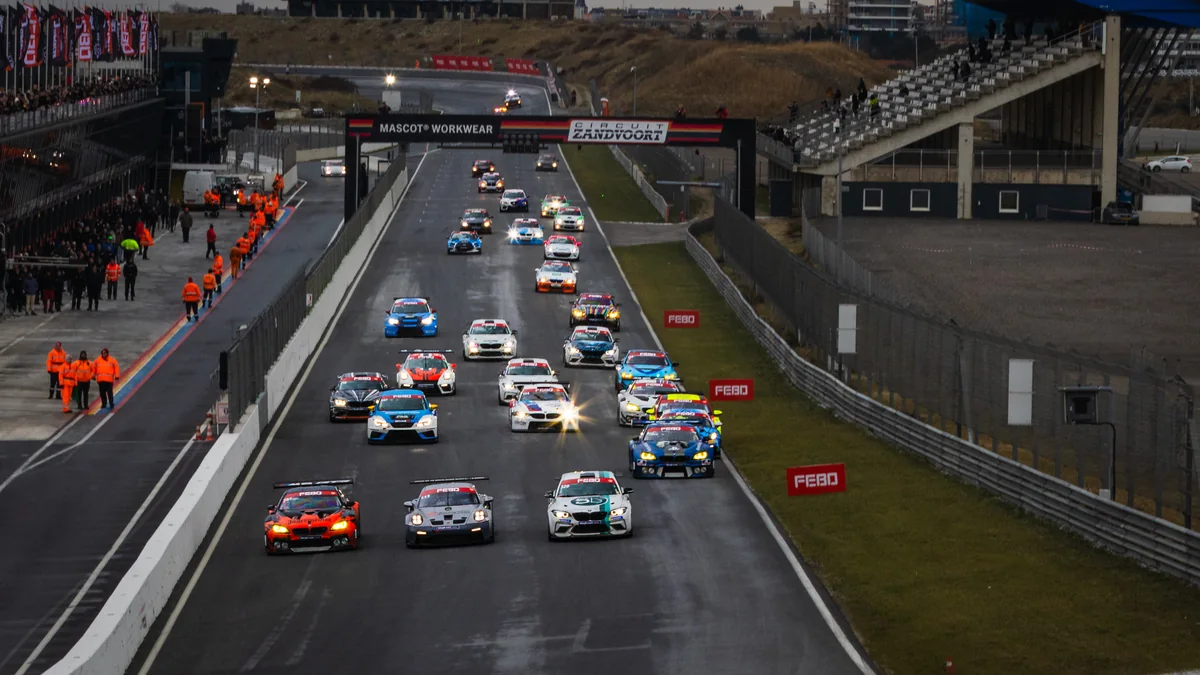 Field of GT and touring cars at the start of a winter race on the main straight at Circuit Zandvoort