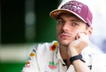 Max Verstappen with his chin on his hand in the Austin paddock