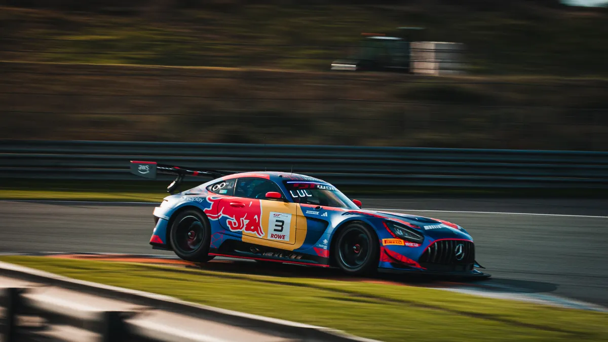 The number 3 Verstappen Racing Mercedes-AMG in Red Bull colours at speed past the barriers