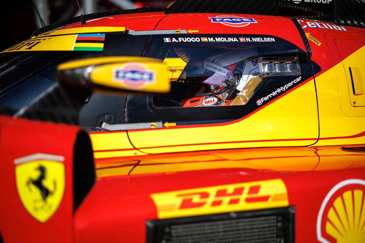 The red and yellow #50 Ferrari 499P with the names of Fuoco, Molina and Nielsen above the cockpit