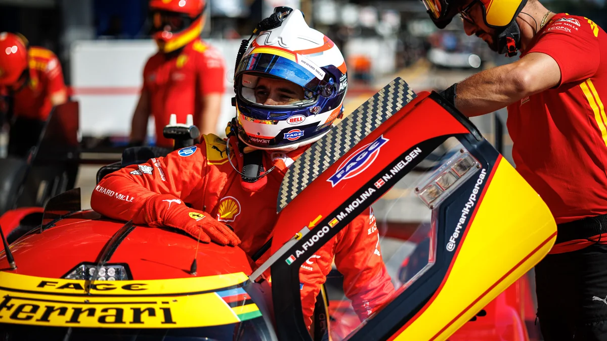 Antonio Fuoco climbs out of the #50 Ferrari 499P, with the names Fuoco, Molina and Nielsen on the door