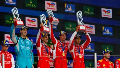 The Toyota drivers lift their trophies on the Barcelona podium, with the second Toyota crew and a Ferrari driver alongside